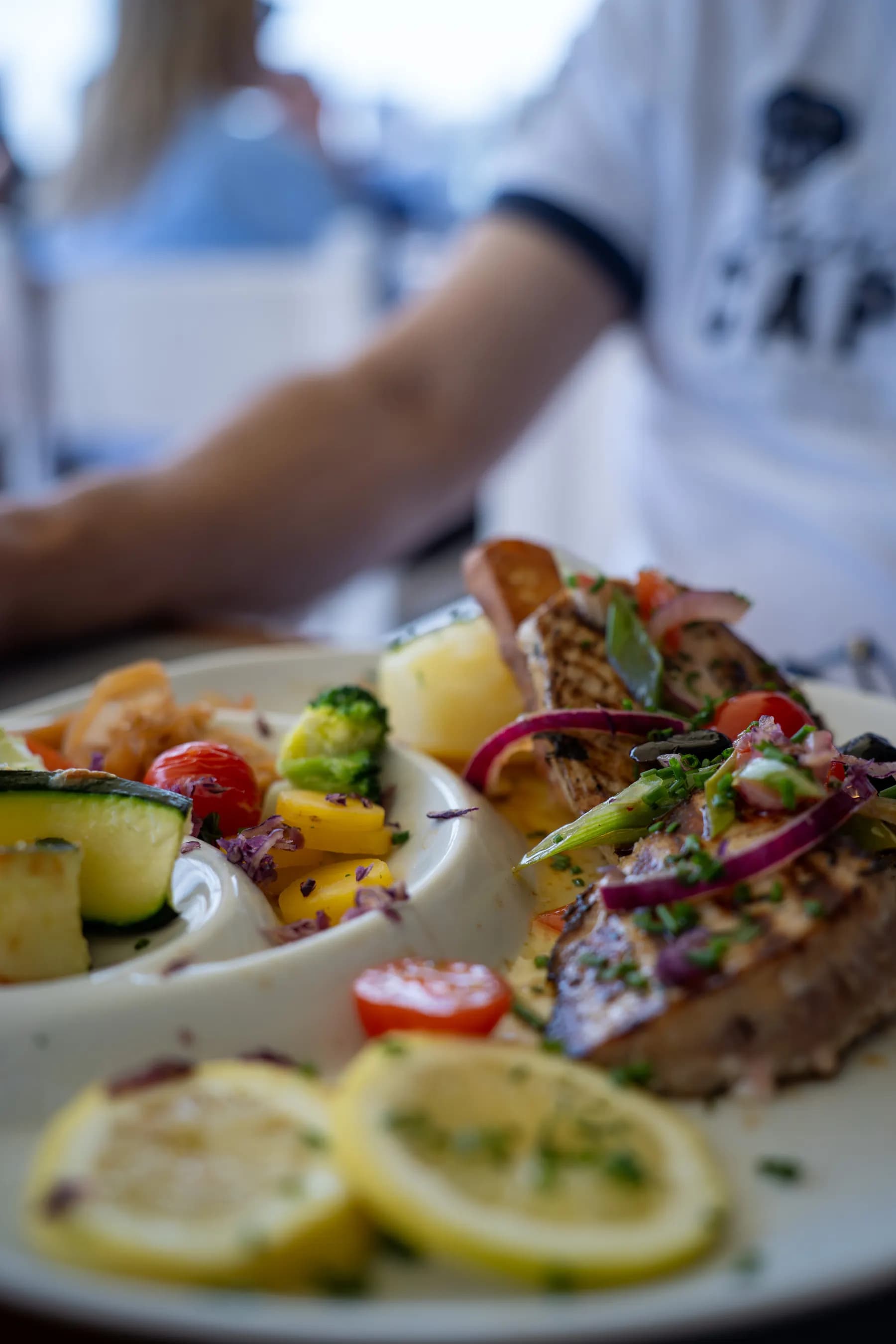 Mediterranean fish served with lemon and seasonal vegetables